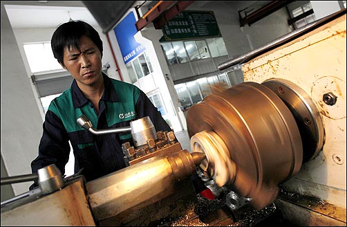 A labourer works at a valve factory in Wenzhou.