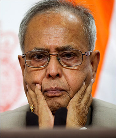 Finance Minister Pranab Mukherjee is all attention at a press conference.