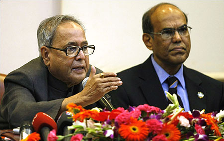 Finance Minister Pranab Mukherjee (L) speaks as Reserve Bank of India's (RBI) Governor Duvvuri Subbarao watches.