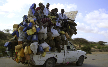 Residents ride on a pick-up truck that supplies milk and other items in Somalia's capital Mogadishu.