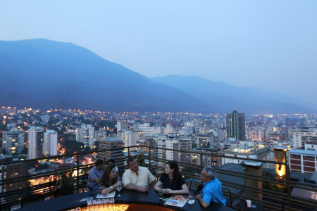 People have a drink at 360, a three-tiered rooftop bar, in Caracas.