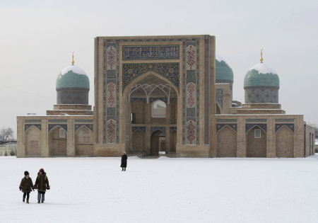 People walk across a snow covered Khast Imam square in Tashkent.