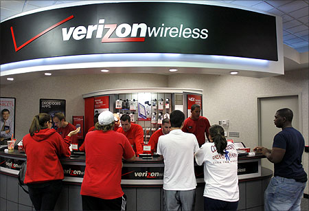 Customers purchase the iPhone 4 shortly after the phone went on sale with the Verizon Wireless network in Boca Raton.