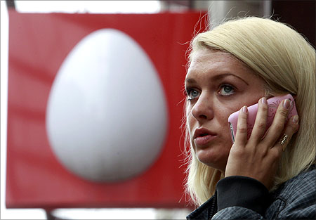 A woman speaks on the phone near an office of Russia's mobile phone operator MTS.