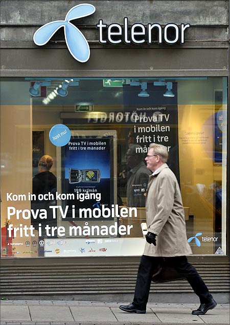 A pedestrian walks past a Telenor store in central Stockholm.