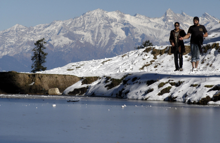 Tourists visit an area covered in snowfall in Narkanda.