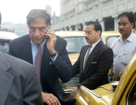 Ratan Tata talks on his mobile phone while looking for a taxi on a jammed road in Kolkata.