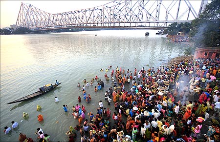 Hindu devotees worship the Sun god on the banks of the river Ganges on the occasion of Chhat Puja in Kolkata.