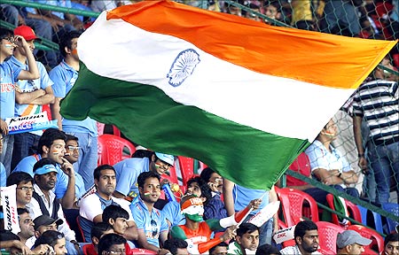 A fan waves the Indian national flag before the ICC Cricket World Cup group B match between India and Ireland in Bangalore.