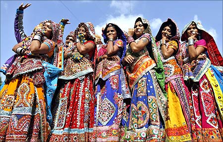 Dancers dressed in traditional attire pose after taking part in rehearsals for the Garba in Ahmedabad.