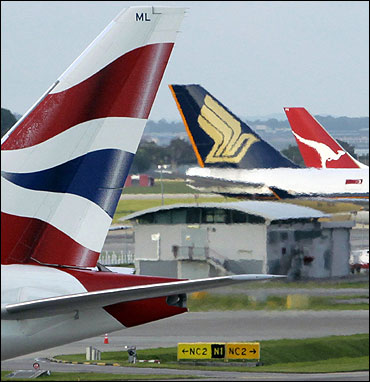 The tail wings of (L-R) British Airways, Singapore Airlines and Qantas Airways.