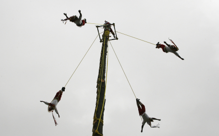Men from Papantla perform the flying rope ritual by descending from the top of a 30-foot-high wooden post during the cultural carnival in Valparaiso.
