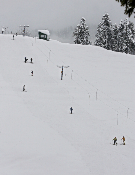 Skiers are seen on a slope after a snowfall in Gulmarg, west of Srinagar.