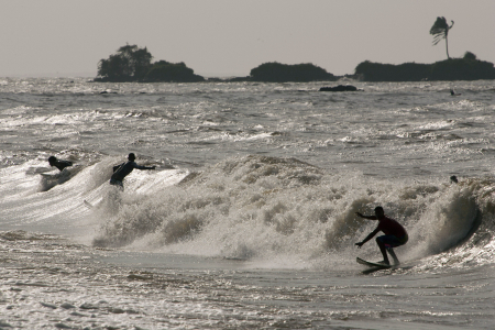 Surfers ride the waves in Marajo Bay near the mouth of the Amazon River.