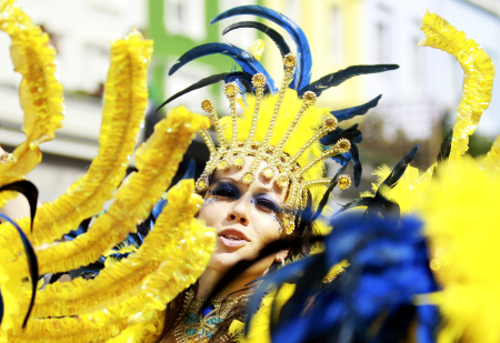 A performer dances in the street parade at the annual Notting Hill Carnival in central London.