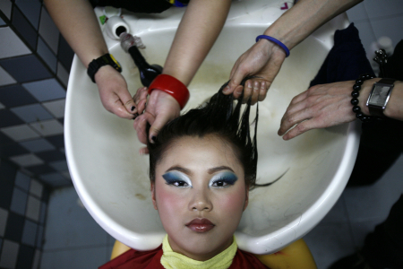 Students wash their classmate's hair in China Fukang Beauty and Hair School in Shanghai.
