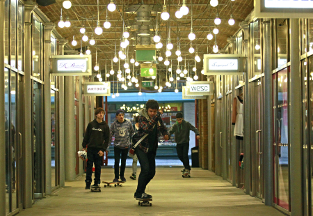 Youths skateboard through a shopping arcade at Covent Garden in London.