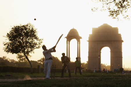 Children play cricket near the India Gate in New Delhi.