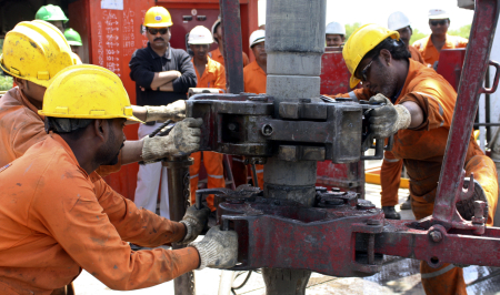 Engineers of Oil and Natural Gas Corp work inside the Kalol oil field in Gujarat.