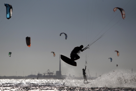 Kite surfers are seen at St Kilda beach in Melbourne.