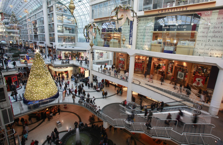A Christmas tree is seen in the midst of shoppers in a major downtown shopping mall in Toronto.