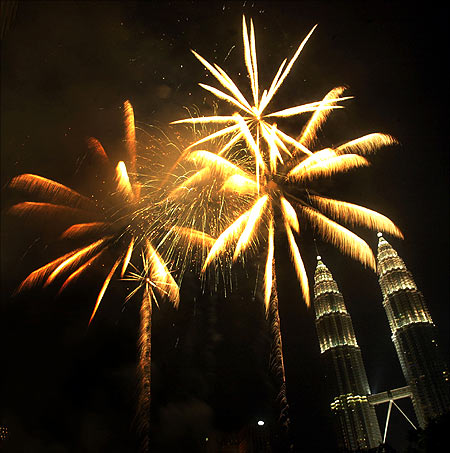 Fireworks explode on top of Malaysia's Petronas Twin Towers in Kuala Lumpur.
