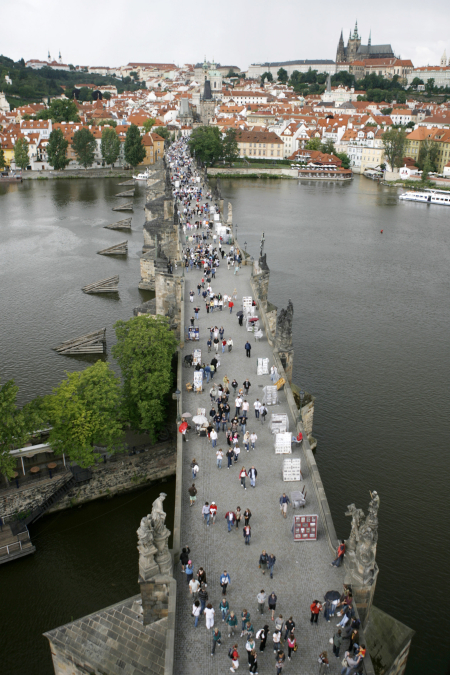 Tourists walk across the medieval Charles Bridge in Prague.