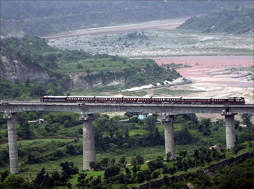 A passenger train coming from Udhampur moves over a bridge in Bazalata on the outskirts of Jammu.