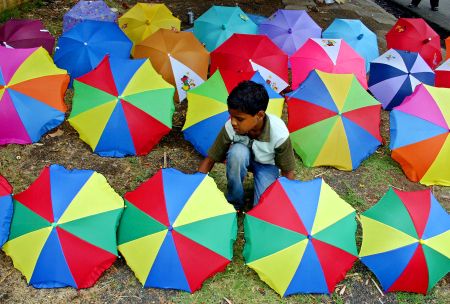 A boy prepares to sell his umbrellas in Bhopal.