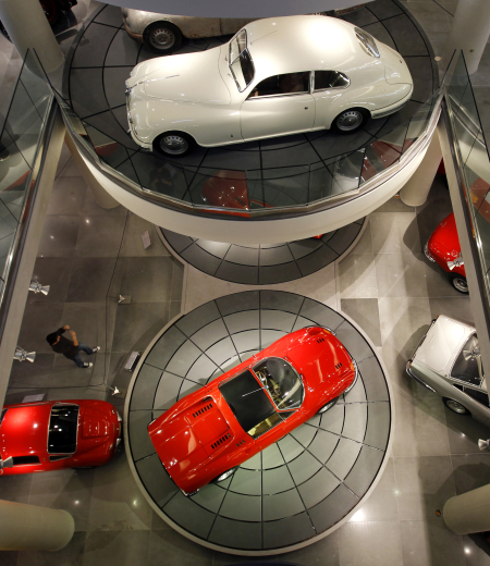A man photographs cars on display at the Hellenic Motor museum in Athens.