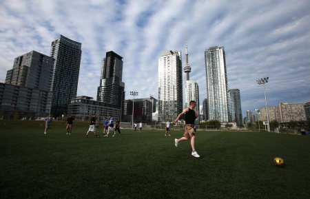 People play a game of pickup soccer in downtown Toronto.
