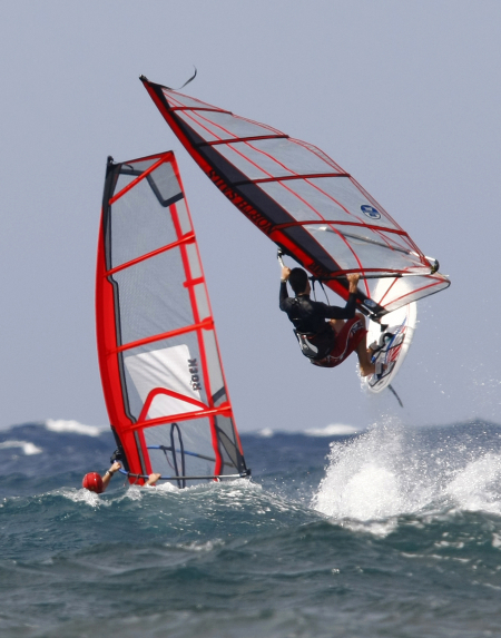 A man performs a jump while windsurfing off Bahar ic-Caghaq.