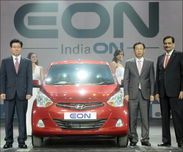 (From L to R) S T Kim, COO, HMC, along with H W Park, CEO, HMIL, and Arvind Saxena, director marketing and sales, HMIL at the global premier of Hyundai EON.