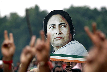 Supporters hold a cut-out of Mamata Banerjee.