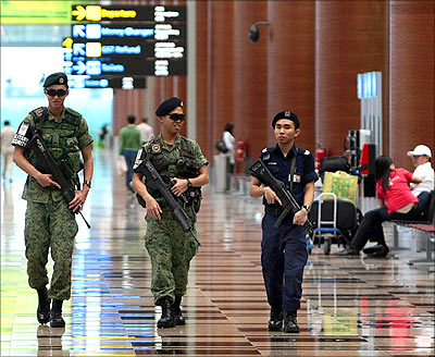 Soldiers patrol inside the check-in area at Singapore's Changi Airport.