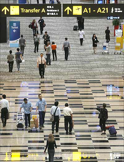 Passengers walk inside the newly opened Terminal 3 at Singapore's Changi Airport.