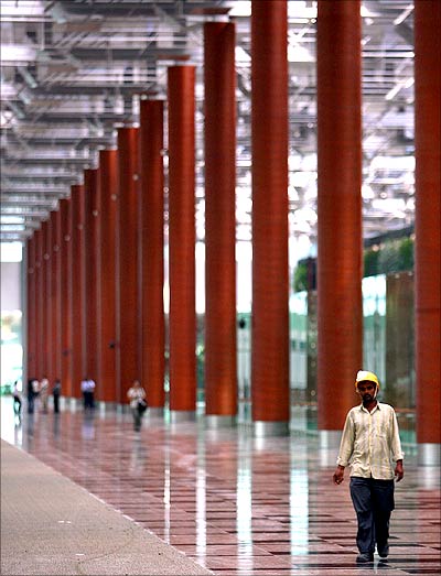 A construction worker walks inside Singapore's Changi Airport Terminal Three.