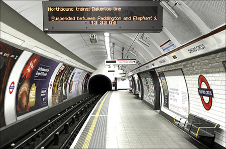 An illuminated sign hangs above an empty Bakerloo line platform at Oxford Circus station, in central London.