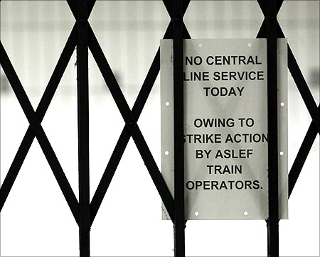 A service status notice is attached to gates at Oxford Circus station, in central London,