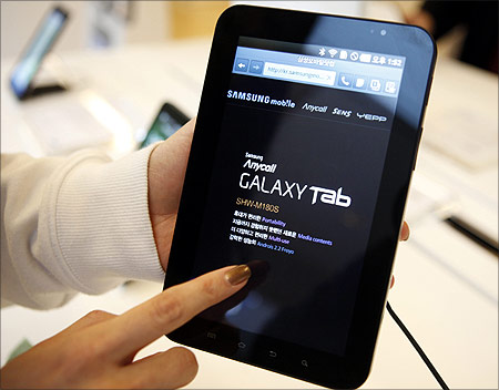 An employee of Samsung Electronics demonstrates Samsung's Galaxy Tab.