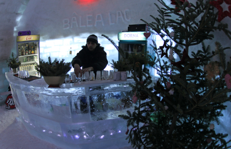 A bartender arranges ice glasses inside the Balea Lac Hotel of Ice in the Fagaras mountains.