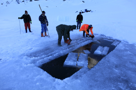 Workers cut ice bricks for the Balea Lac Hotel of Ice in the Fagaras mountains.