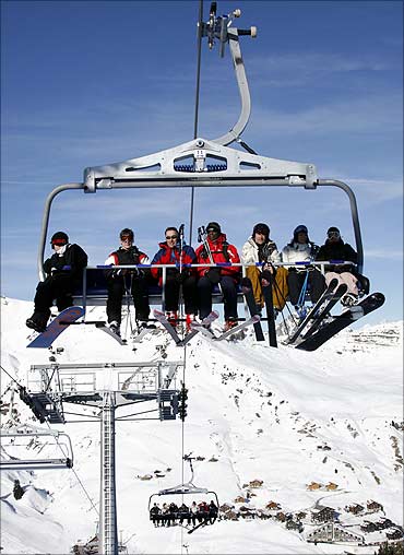 Skiers on a chairlift are at Les Crosets, east of Geneva.