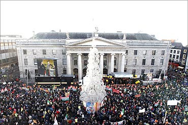 People gather in front of the General Post Office Building on O'Connell Street, in Dublin.