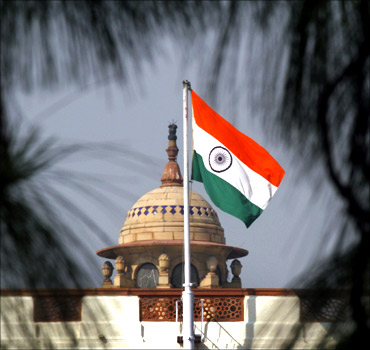 An Indian national flag flutters on top of the Parliament building in New Delhi.