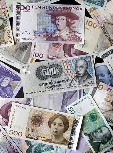 Swedish kronor, Norwegian kronor, and Danish kronor notes in various denominations are seen.