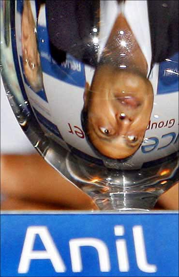 Anil Ambani's image reflected in a glass.