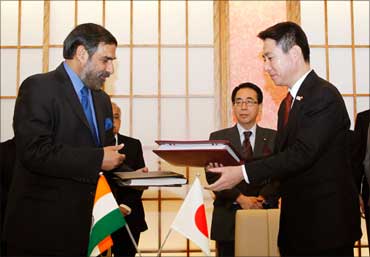 Trade Minister Anand Sharma and Japan's Foreign Minister Seiji Maehara exchange documents after signing the Comprehensive Economic Partnership Agreement in Tokyo on February 16, 2011.