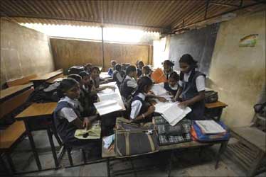 Schoolgirls study in a classroom of a government-run school in Hyderabad.