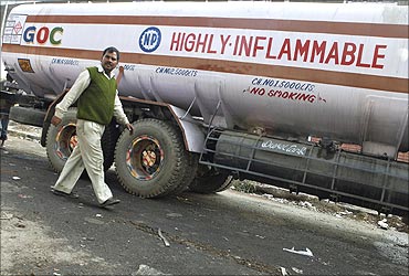 A driver of a diesel tanker walks outside an oil depot in New Delhi.